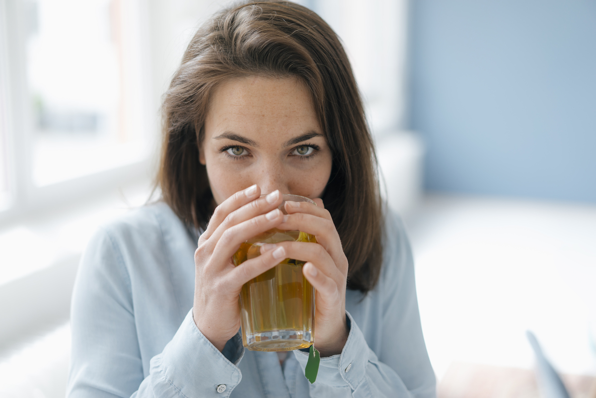 woman drinking warm tea after root canal treatment
